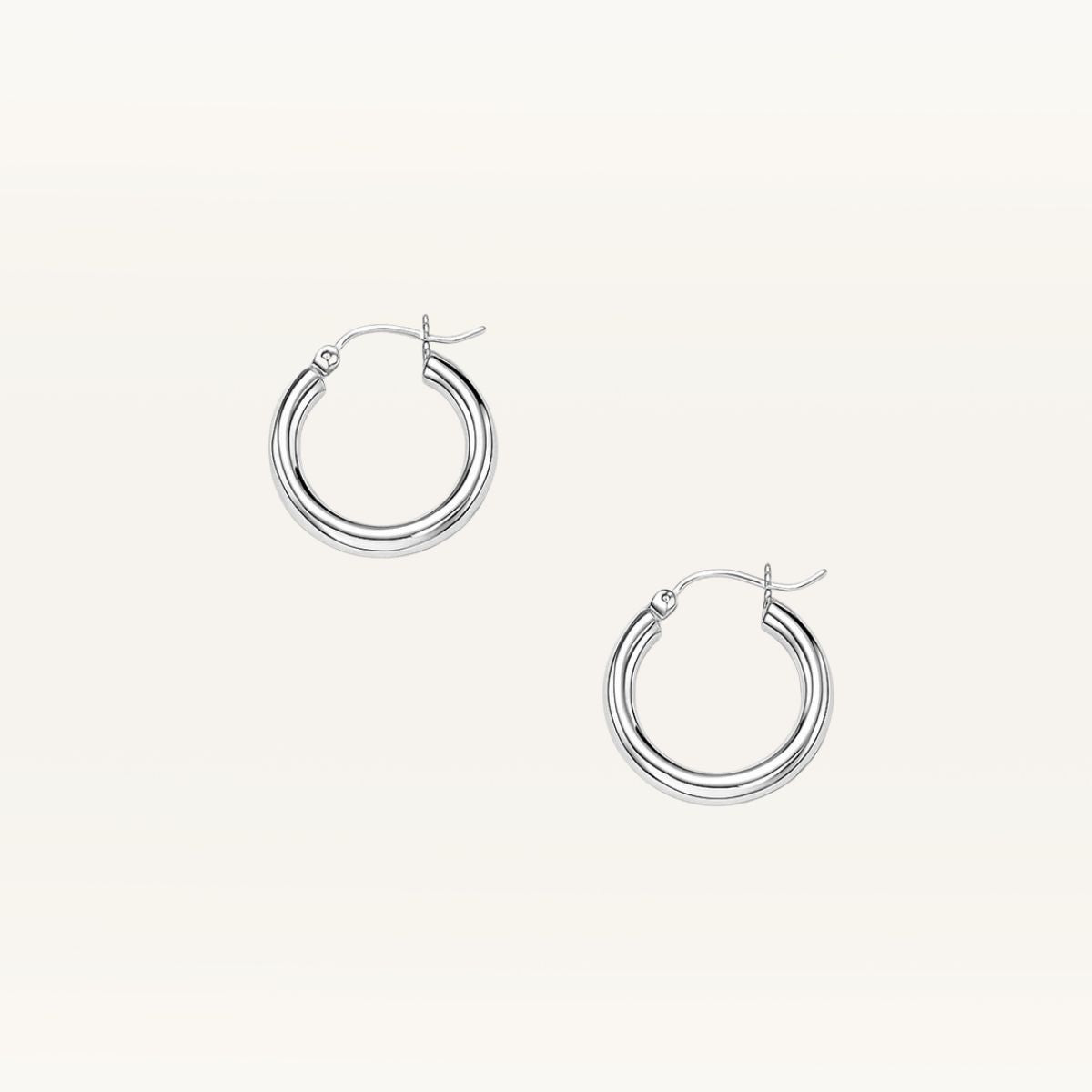 Pair of silver hoop earrings on a light gray background