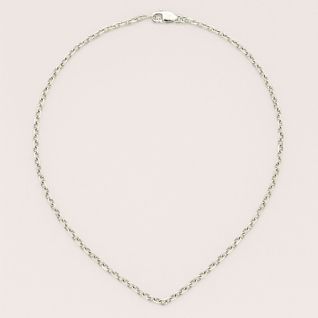 Silver necklace on a light pink background