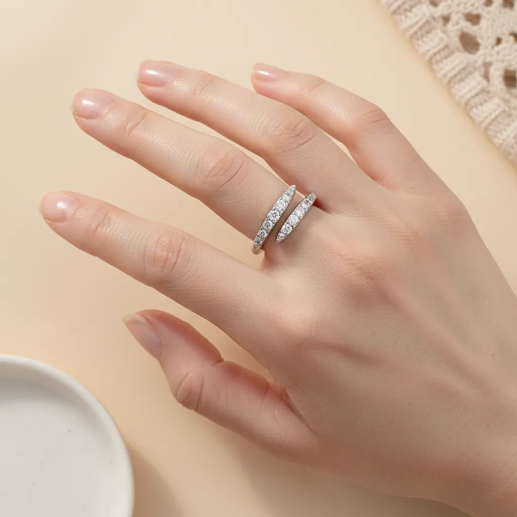 Silver moissanite ring on a hand with a neutral background